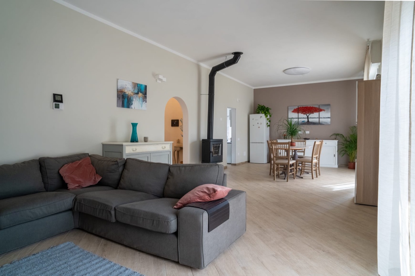The television corner of the living room, facing the brick arch